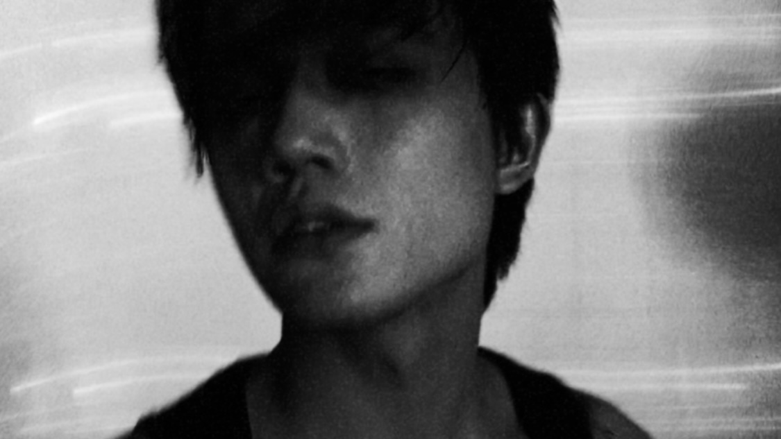 Monochrome half-length portrait in light and shadow